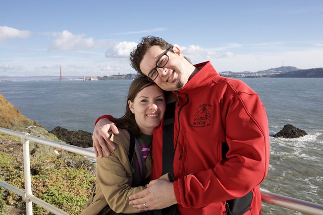 Couple Embracing with Golden Gate Bridge Behind