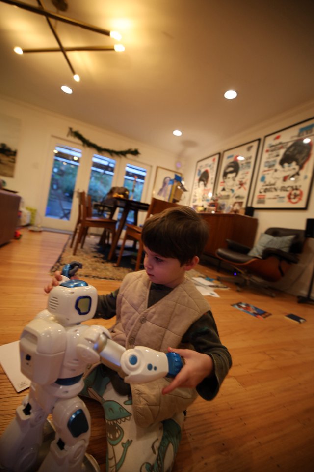 Child Playing with Robot Toy in Cozy Living Room