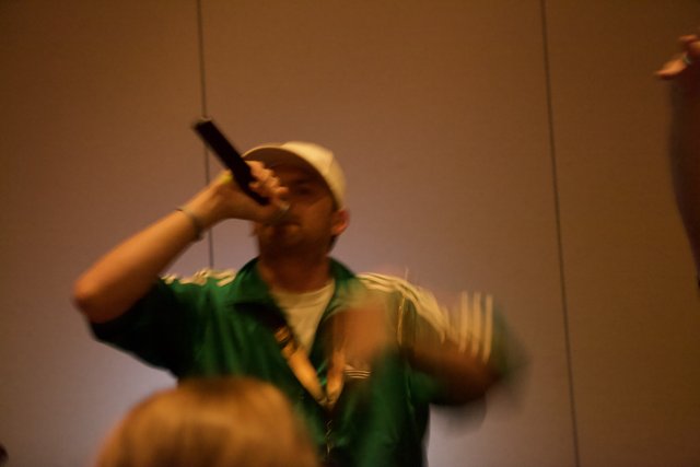 Green-Shirted Man on the Mic