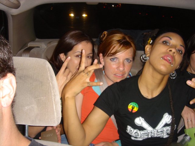 Three Friends Laughing in a Vehicle at Night
