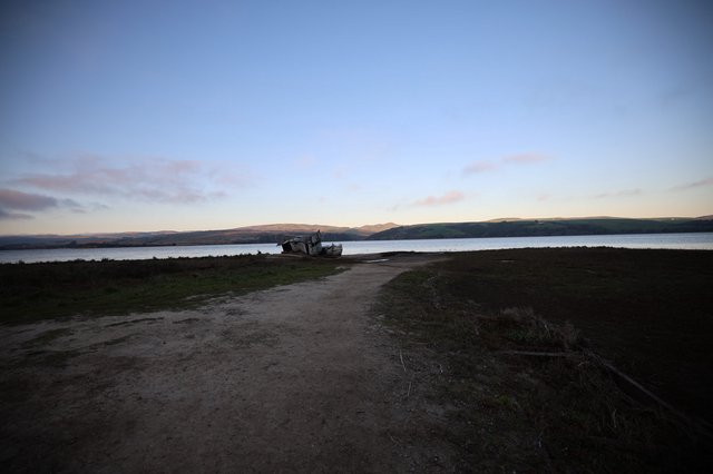 Shipwreck at Twilight on Coastal Bay