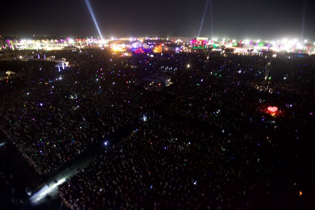 Coachella Crowd Under a Glowing Metropolis Sky