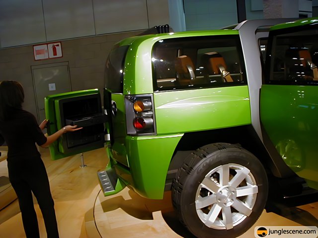 Woman opens door to sleek green SUV