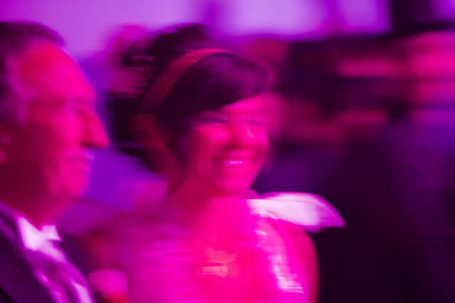 Blur of a Purple-Clad Woman Dancing in the Dark