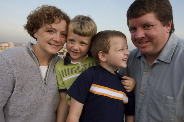 Happy Family Portrait at Sunset Overlooking the City