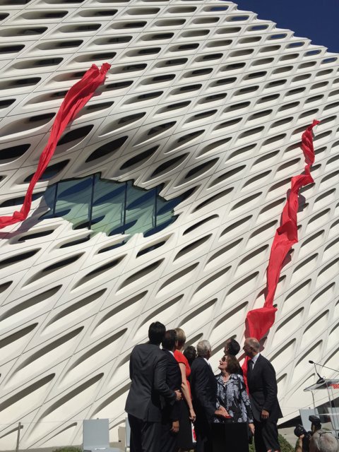 Group of People with Red Flags in Front of The Broad