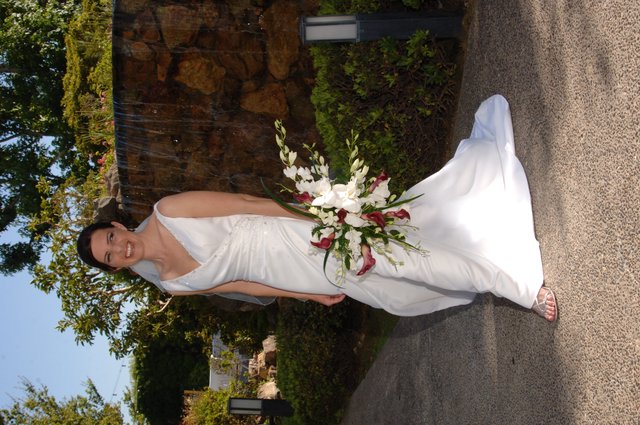 Radiant Bride Poses Before Stone Waterfall Feature
