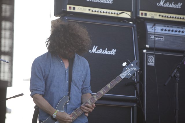 Curly-haired musician strums his guitar at FYF Festival