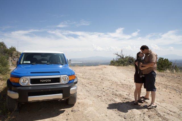 An Adventurous Couple and Their Blue SUV