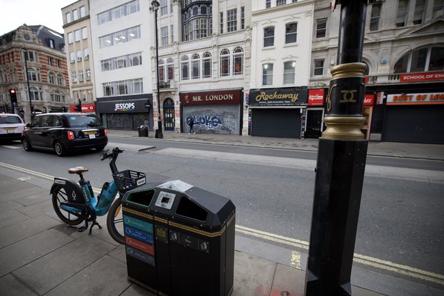 Urban Street Scene with Bike Share and Recycling Bin