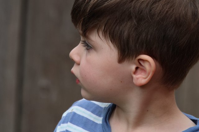 Profile Portrait of Young Boy in Striped Shirt