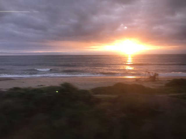 Train Window Sunset Over the Ocean