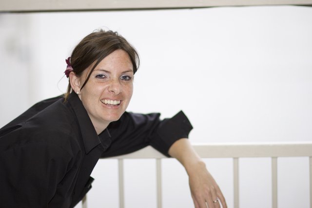 Smiling Woman Leaning on White Railing Portrait