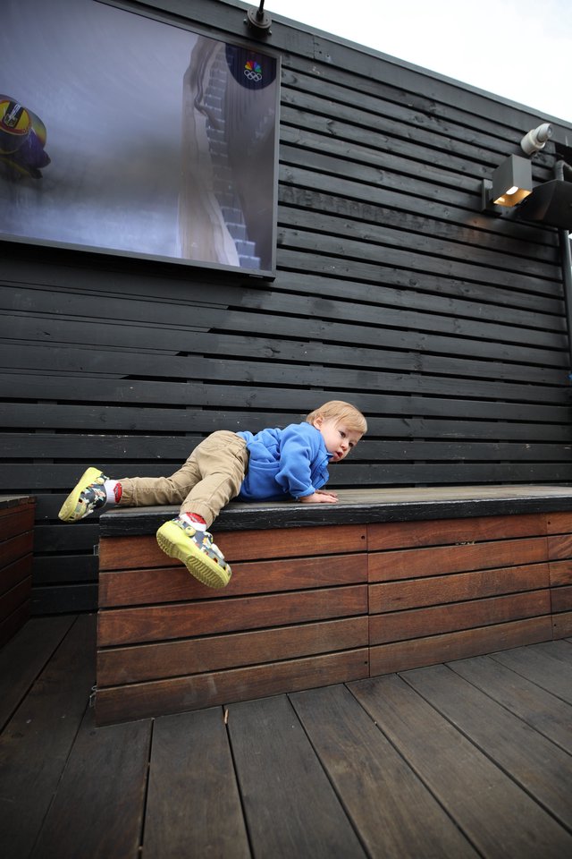 Young Child Climbing Modern Wooden Deck Structure