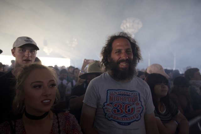 Bearded Man and Smiling Woman in Coachella Crowd