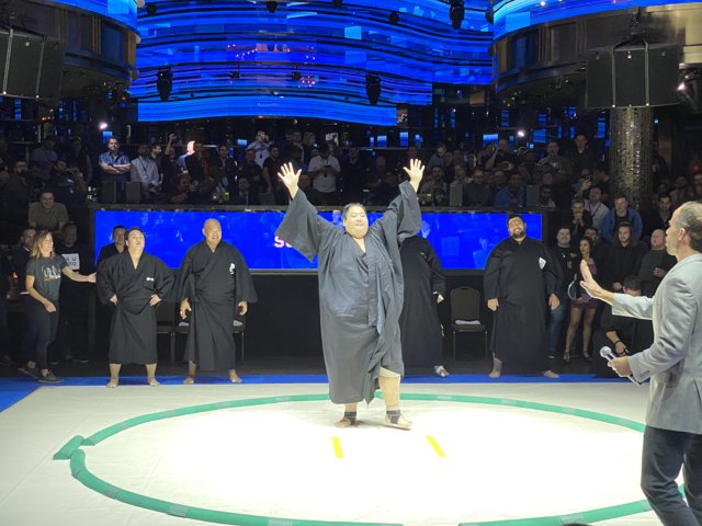 Triumphant Man in Robe at Wrestling Ring