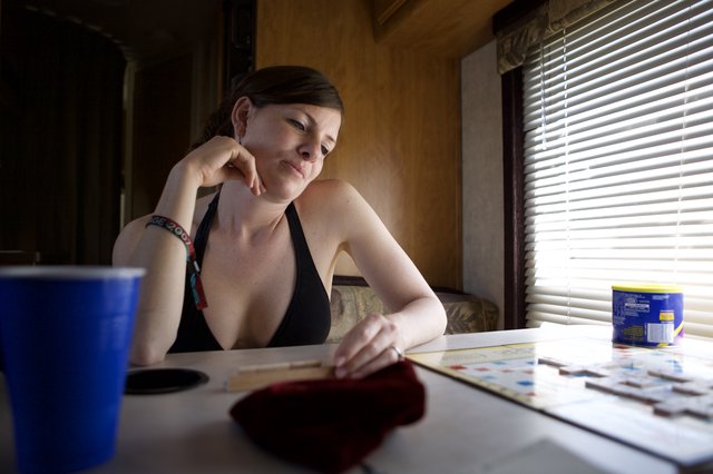 Contemplative Woman Playing Scrabble in RV