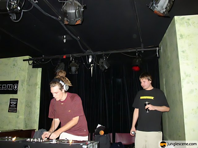 Two Men Working the DJ Mixer