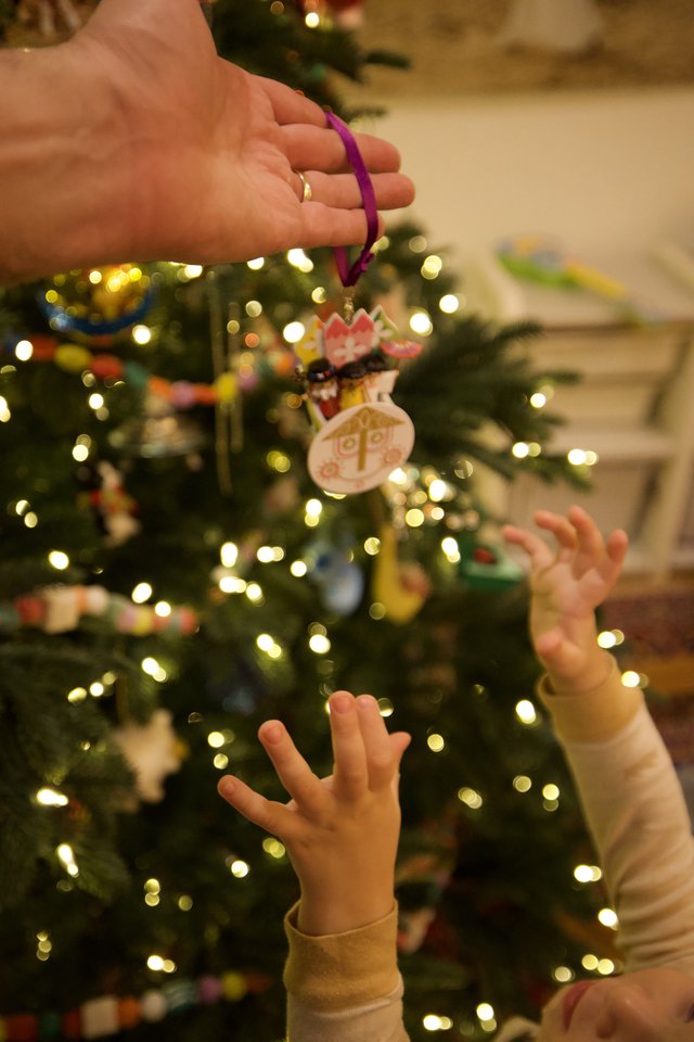 Child Reaching for Handmade Christmas Ornament