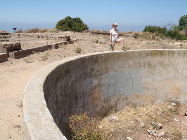 Explorer Poses on Abandoned Concrete Gun Emplacement Ruins
