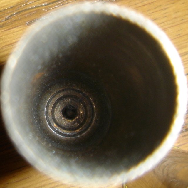Metal Object in Pottery Cup