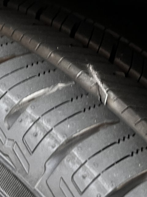 Dangerous Tire Crack Caption: A close up of a tire on a machine showcasing a dangerous crack that must be fixed immediately. #tire #wheel #car #vehicle #spoke #transportation #alloywheel #machinery