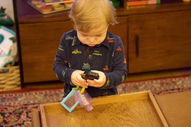 Toddler Playing with Toy Cars at Christmas Time
