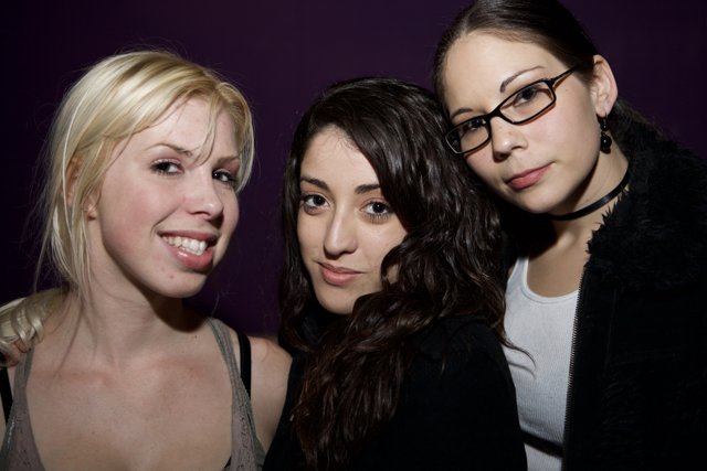 Three Women with Glasses Pose for a Nightlife Portrait