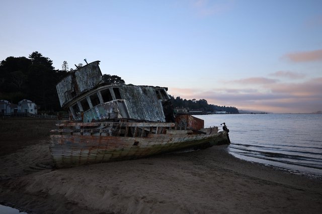 Abandoned Shipwreck on Beach at Twilight