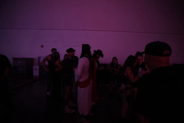 Purple-Lit Crowd Socializing at Wobbleland Festival