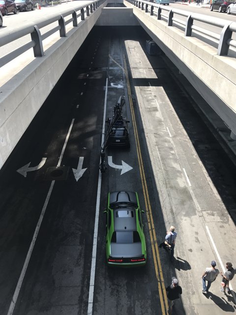 Green Car Parked Under Bridge