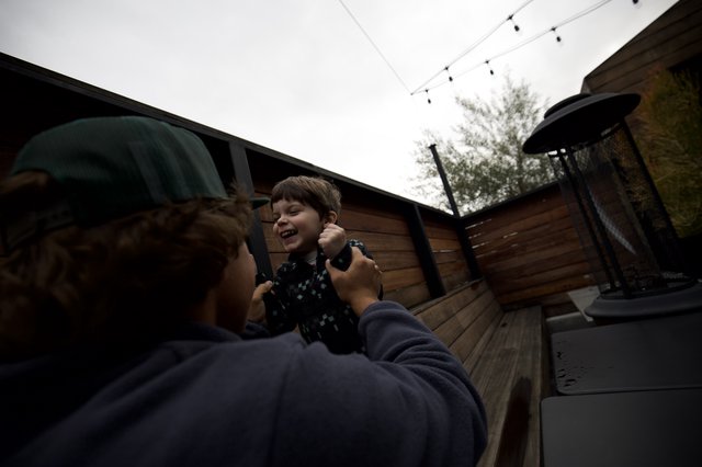 Joyful Moment Between Child and Adult on Outdoor Deck