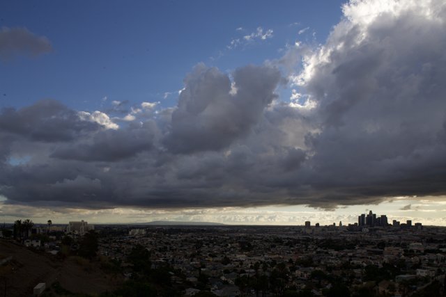 Cityscape under a Blanket of Cumulus Clouds
