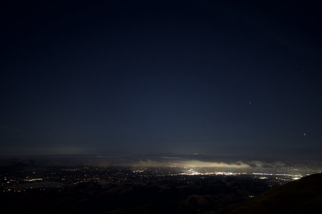 City Lights Glow Beneath Foggy Night Sky from Mount Diablo