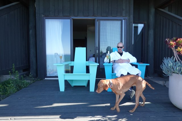 Man Relaxing with Dog on Modern Deck