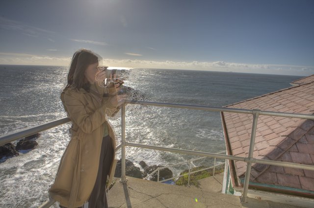 Photographer Capturing the Pacific from Coastal Overlook