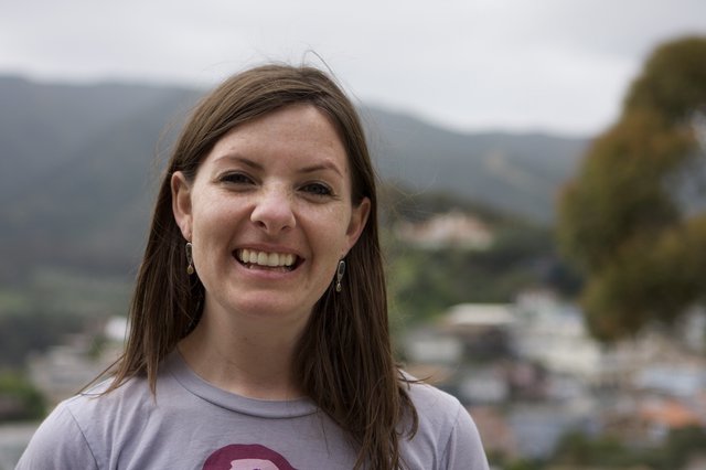 Smiling Woman Portrait Overlooking Mountain Town