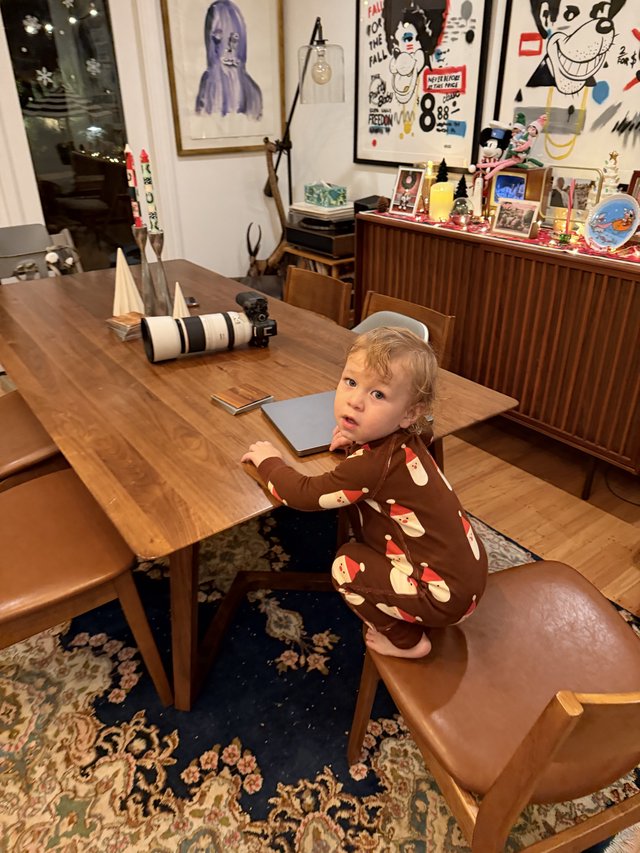 Toddler in Santa Pajamas at Christmas Dining Table