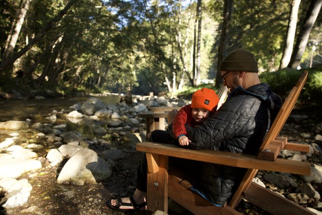 Serenity by the Stream: A Father and Child Moment