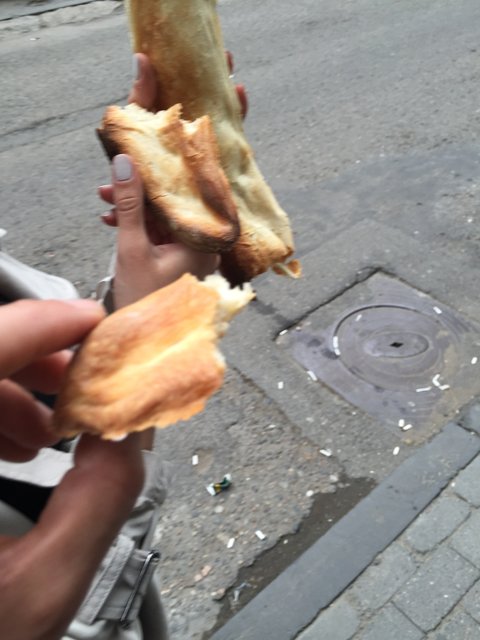A Bread Break on the Sidewalk