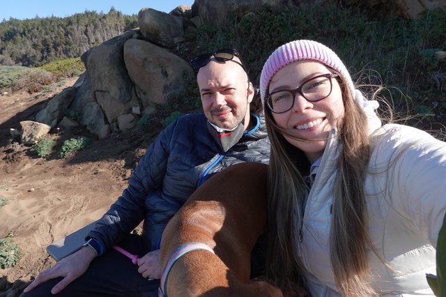 Couple's Selfie with Dog on Rocky Coast