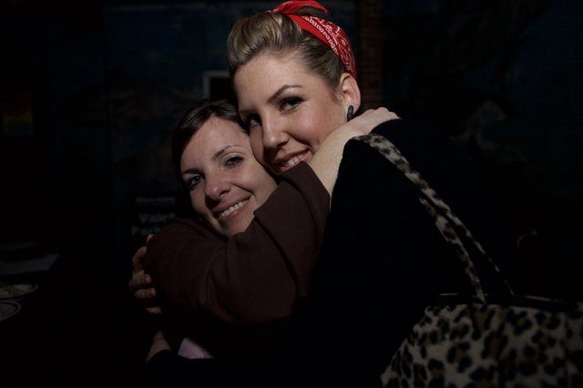 Two Friends Share a Warm Embrace at Night