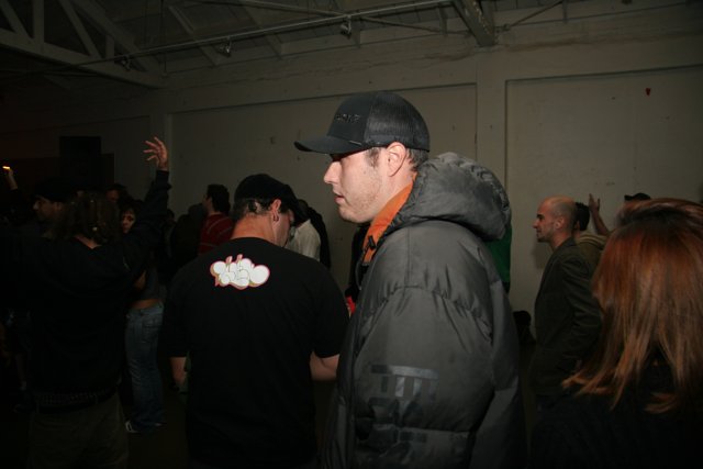 Man in Black Jacket Surrounded by a Crowd