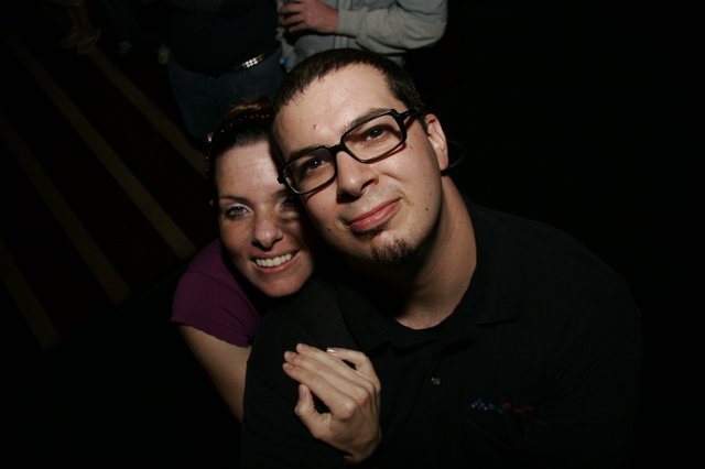 Two Friends Smiling Together at a Nighttime Event