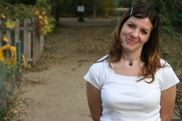 Smiling Woman on Autumn Garden Path