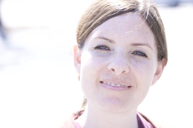 Freckled Woman Smiling in Bright Outdoor Light