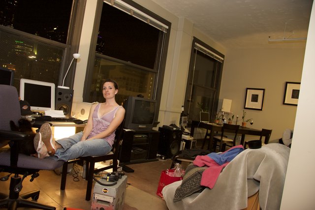 Woman Relaxing in Urban Loft Apartment at Night