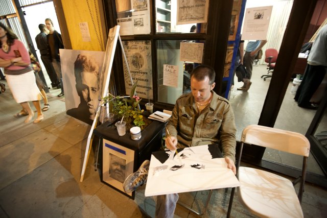 Man Contemplates Artwork at Cafe