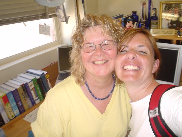 Two Women Laughing Together in Office Setting