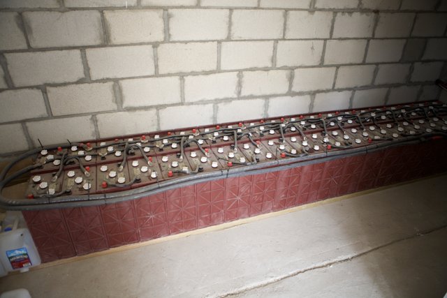 Rows of Electrical Boxes in a Brick Room